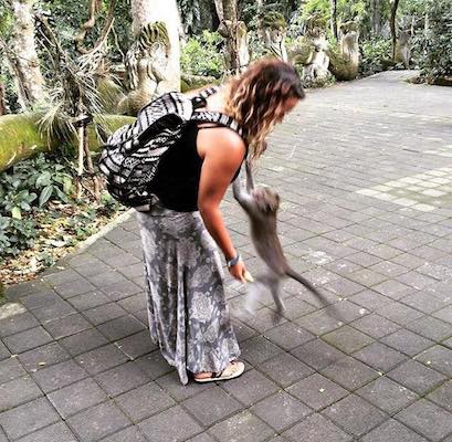 a monkey jumping on my friend at the Ubud Sacred Monkey Forest
